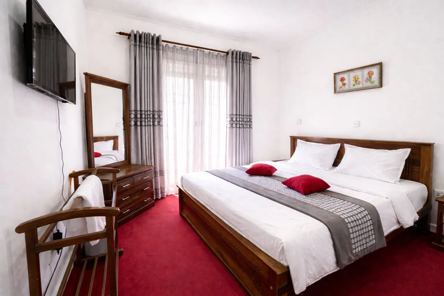 A villa bedroom with warm lighting and made-up bedding