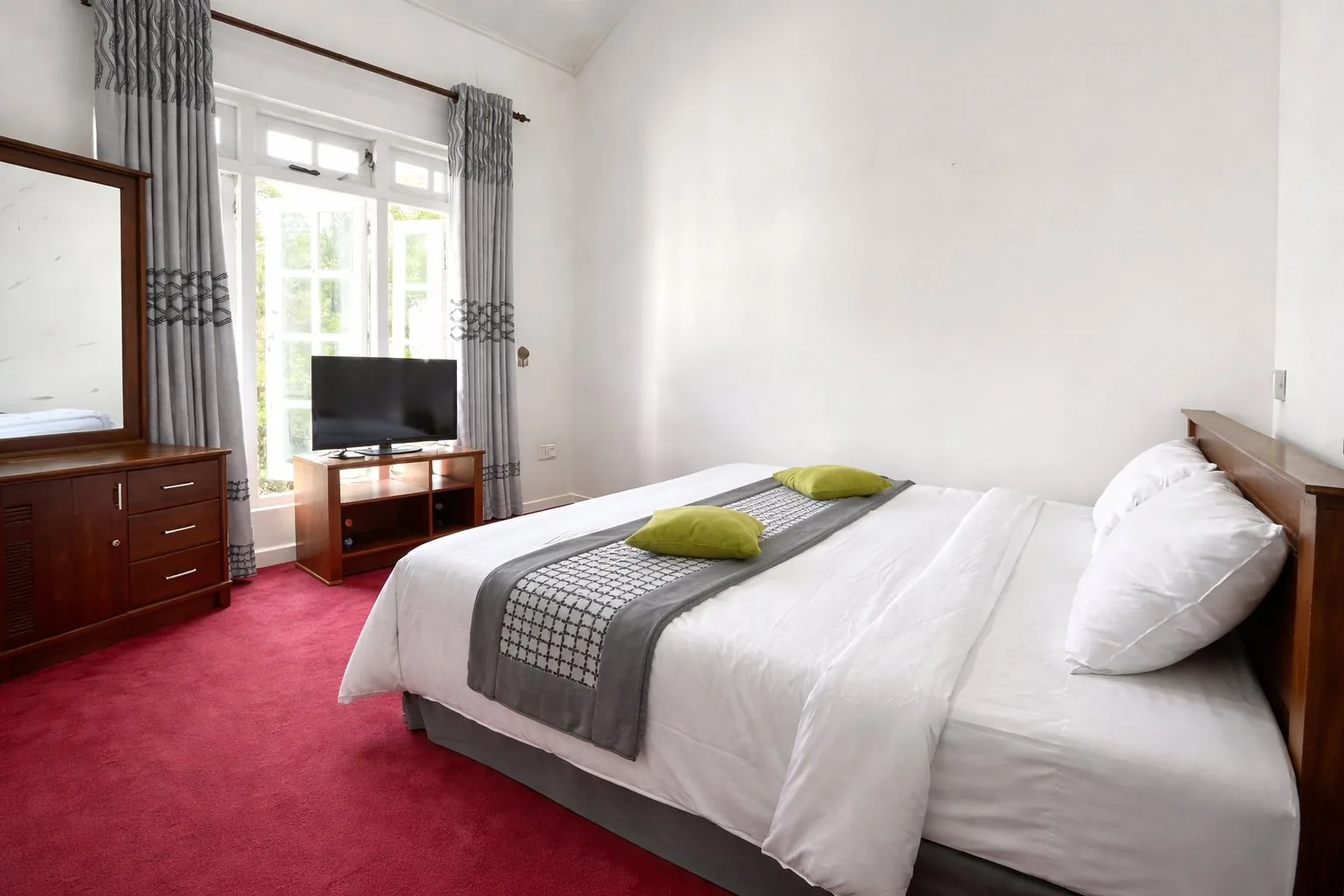 The master bedroom, with plush bedding and warm lamplight