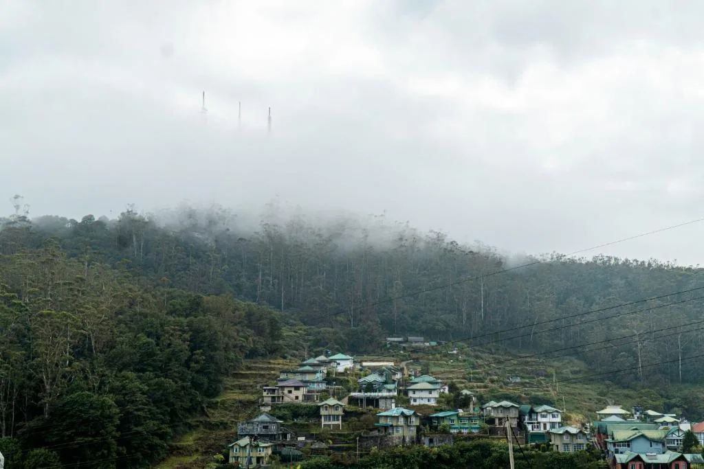 Cloud moving across a forested hillside and village in Nuwara Eliya