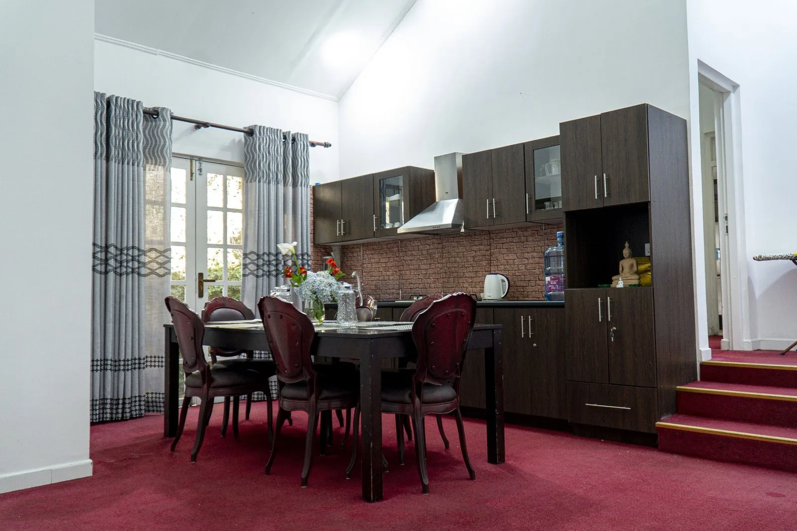 The dining room, laid for a meal, with timber furniture
