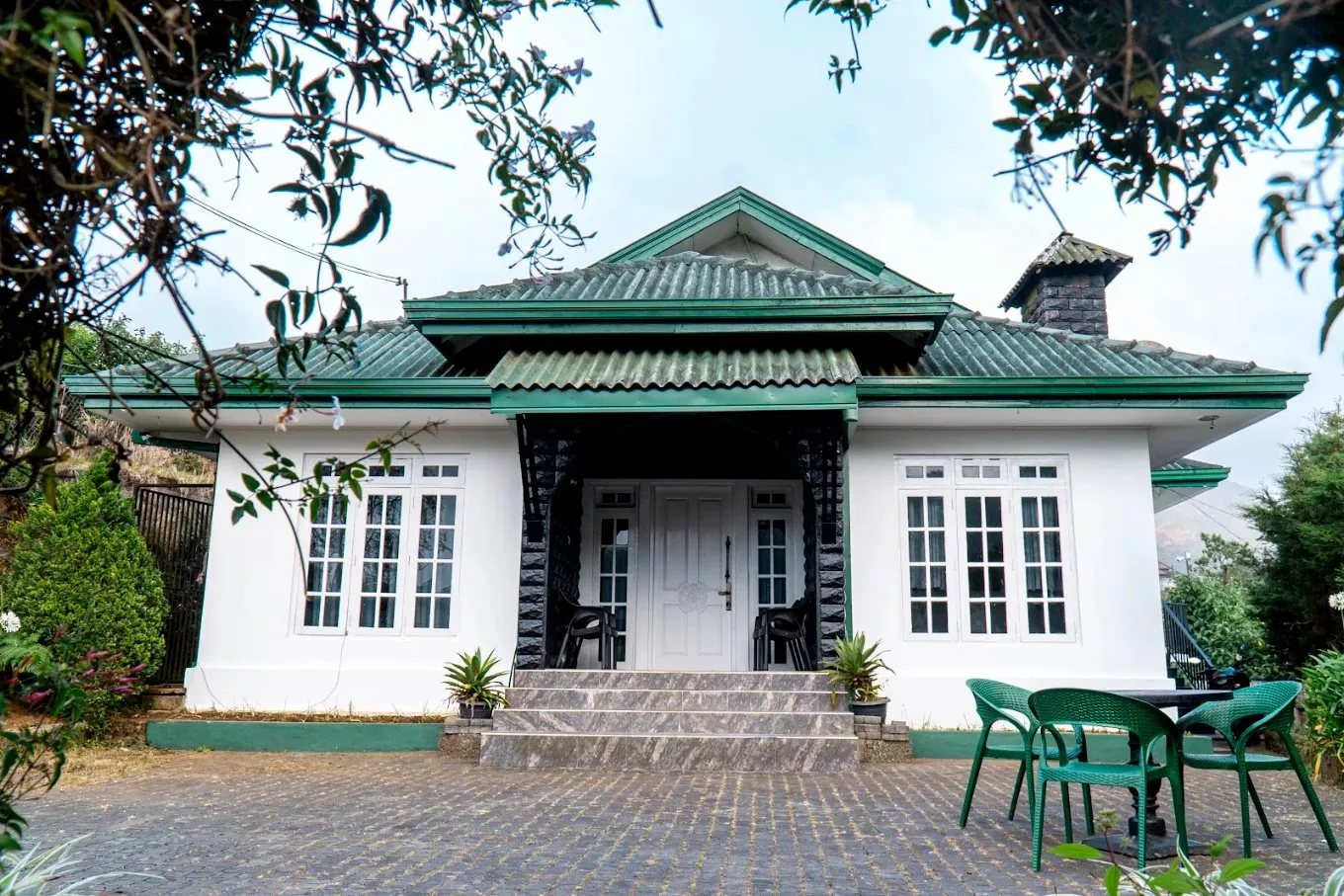The front of Hillcroft Villa, a colonial-style bungalow with a garden